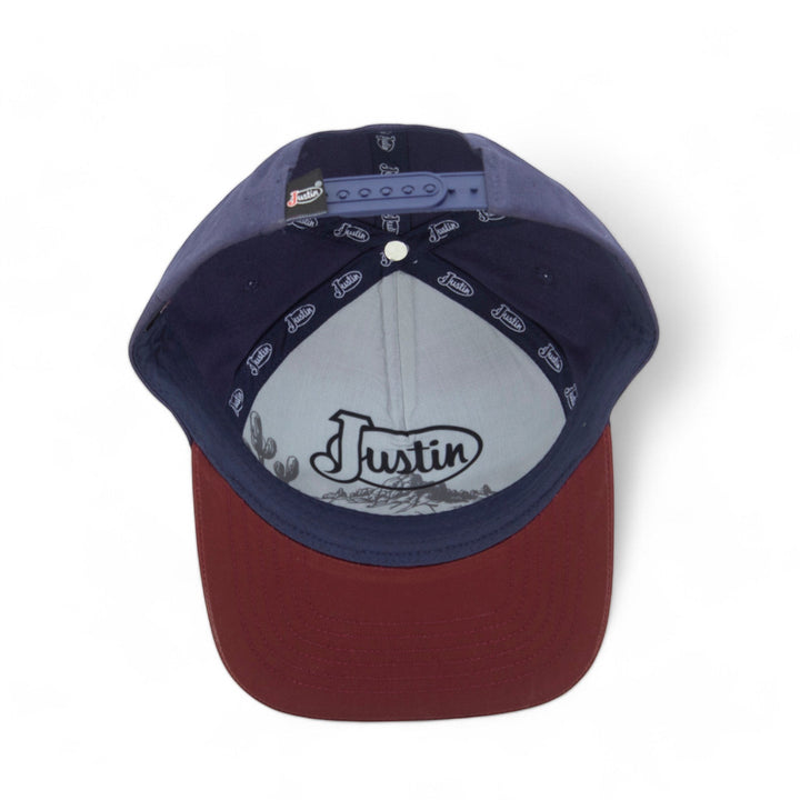 Justin Boots México blue and burgundy polyester baseball cap with curved brim and snap closure. Features sweatband.