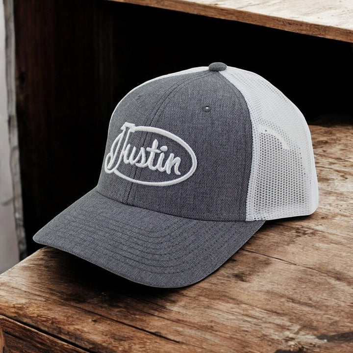 Justin Boots México gray trucker cap with white mesh back and embroidered logo. Adjustable snapback closure.